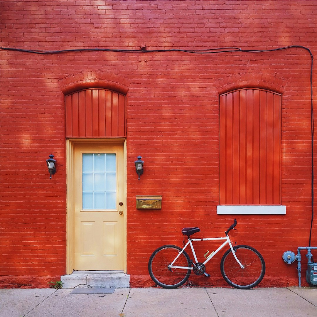 A Bicycle Is Parked In Front Of A Red Brick Building