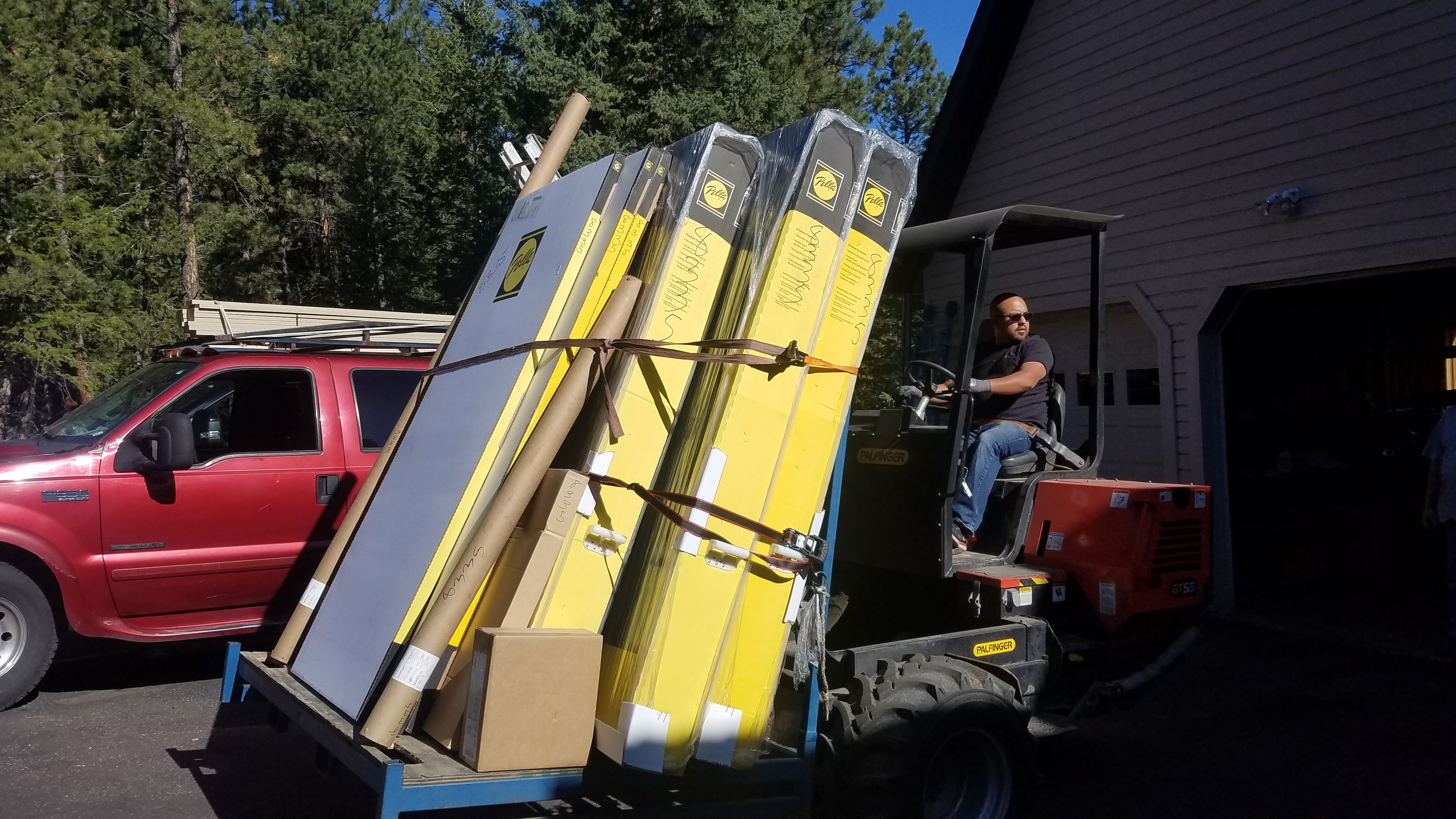 A Man Driving A Truck Loaded With Lumber