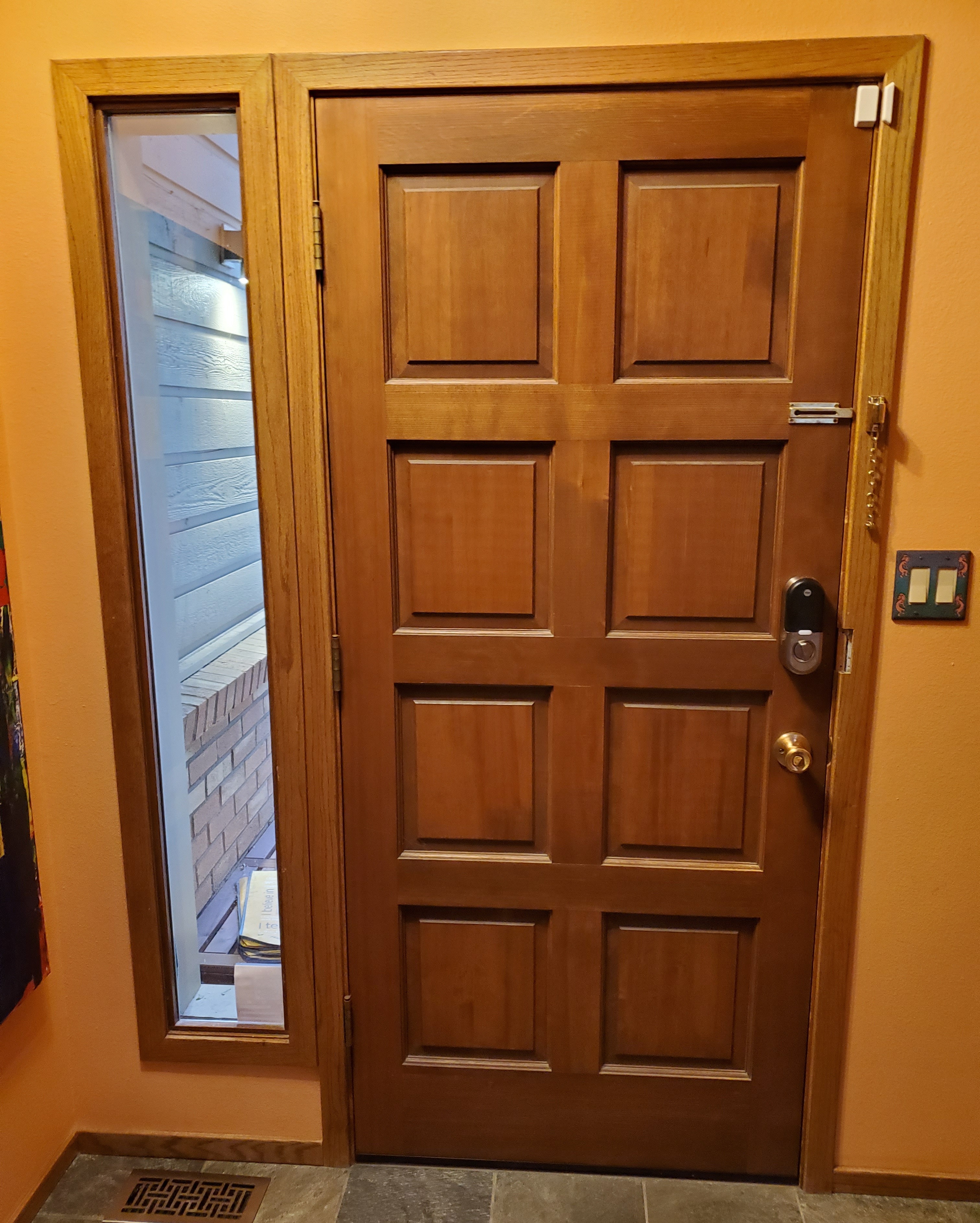 A Wooden Door Featuring A Glass Panel